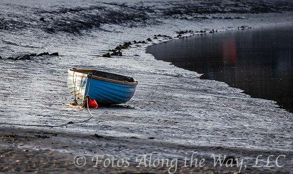Solo Boat and Buoy on Muddy Beach