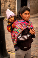 Woman Carrying Child at Bus Stop (Peru)