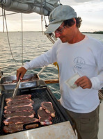 Boat Crew Leader Preparing Steaks (Bahamas)