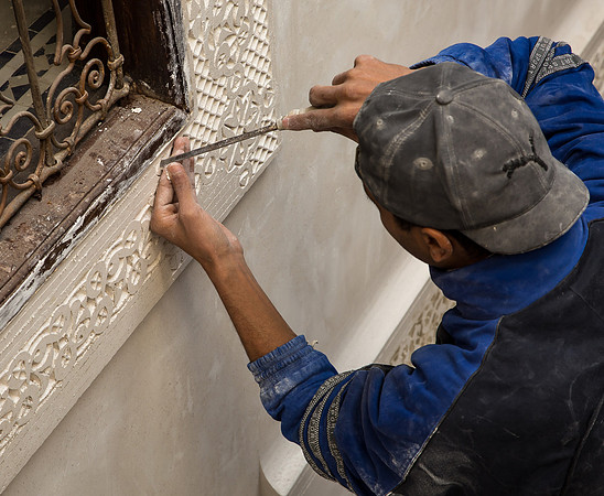 Plaster Renovator Working on a Window Frame (2016)